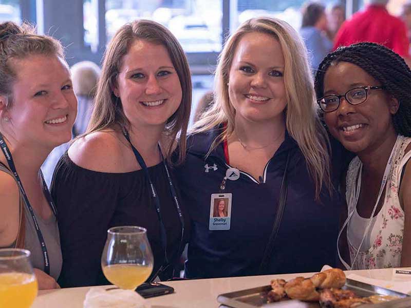 Three people networking at a Heartland social event